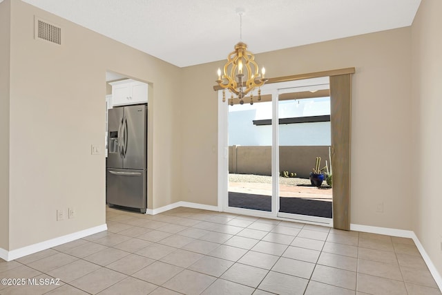 unfurnished dining area featuring a chandelier, visible vents, baseboards, and light tile patterned flooring