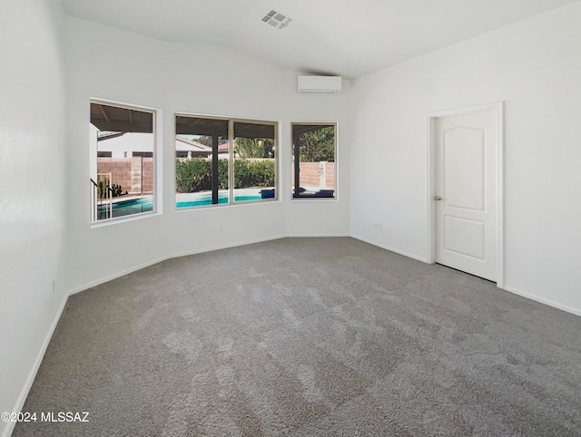 carpeted empty room featuring a wall unit AC