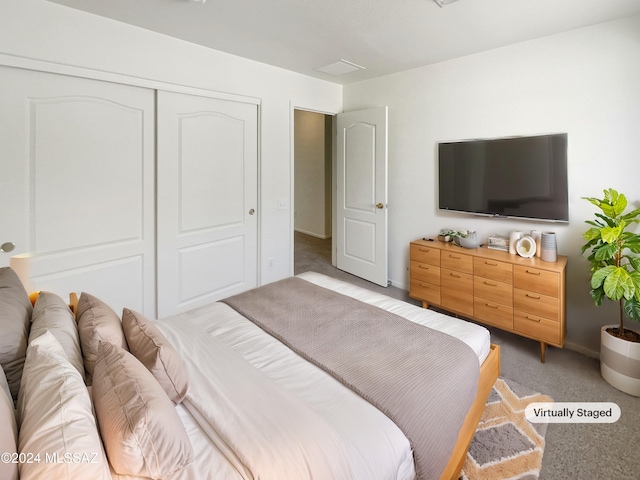 bedroom with light colored carpet and a closet