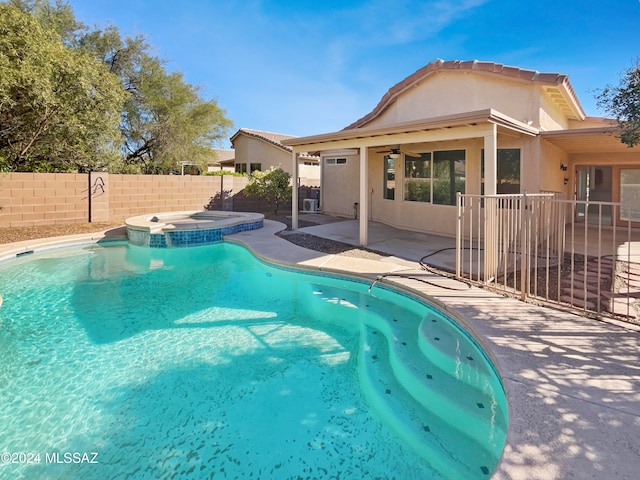 view of pool featuring a patio and an in ground hot tub