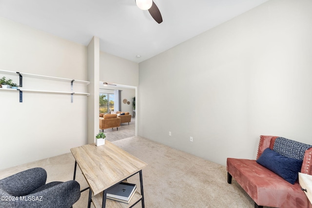 sitting room with ceiling fan and light colored carpet