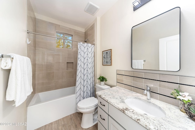 full bathroom featuring tasteful backsplash, vanity, wood-type flooring, shower / bathtub combination with curtain, and toilet