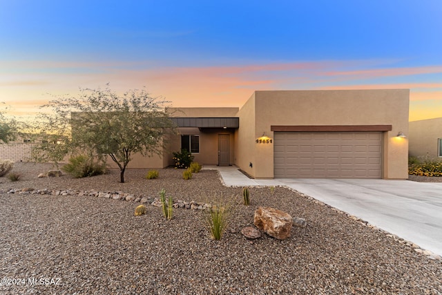 southwest-style home with a garage