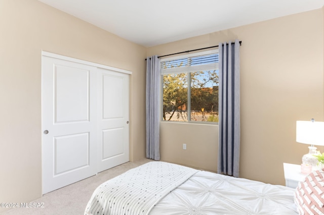 bedroom featuring light carpet and a closet