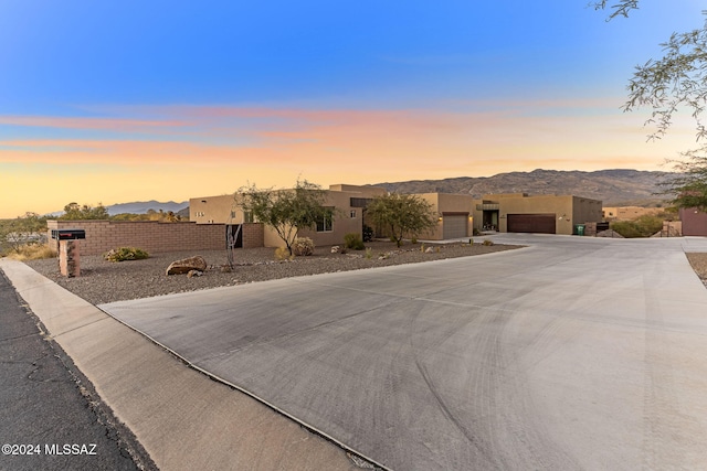 view of front of house with a mountain view and a garage