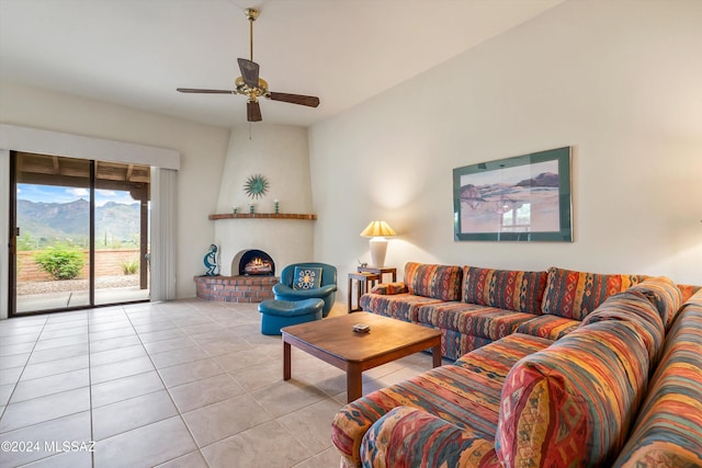 tiled living room featuring ceiling fan and a fireplace