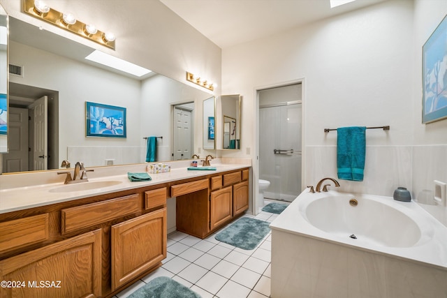 full bathroom with tile patterned floors, vanity, toilet, and independent shower and bath