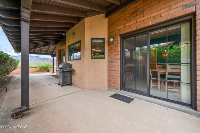 doorway to property featuring a mountain view and a patio area