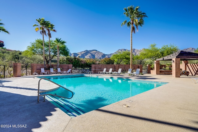 view of swimming pool with a gazebo, a mountain view, and a patio