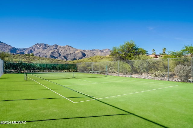 view of tennis court with a mountain view