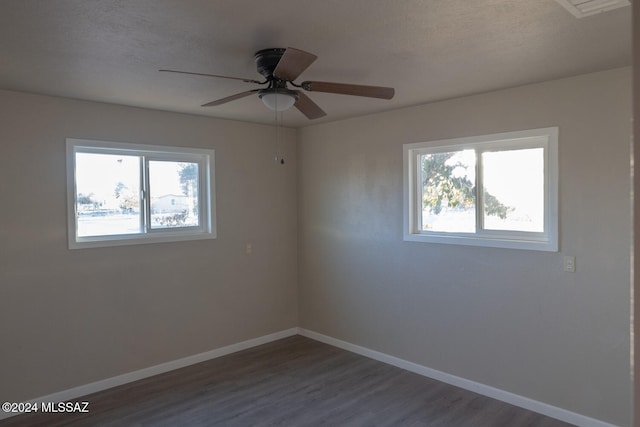 empty room featuring ceiling fan and dark wood-type flooring