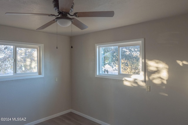 unfurnished room with ceiling fan and wood-type flooring