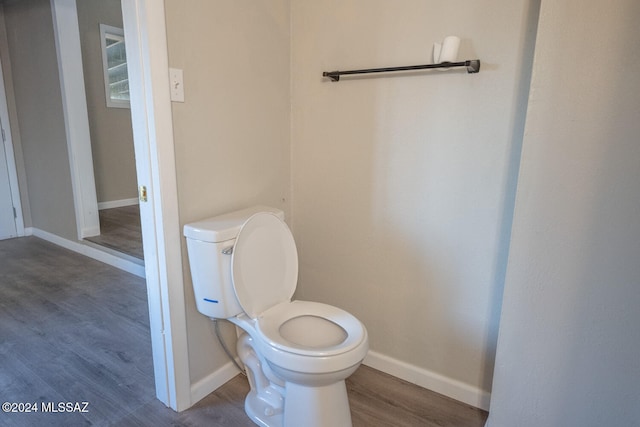 bathroom with toilet and wood-type flooring