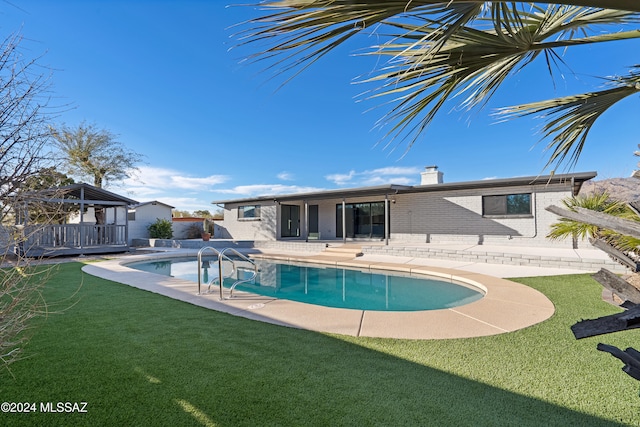 view of pool featuring a yard and a patio area