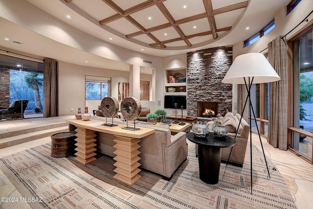 living room featuring a high ceiling, coffered ceiling, built in features, beamed ceiling, and a fireplace