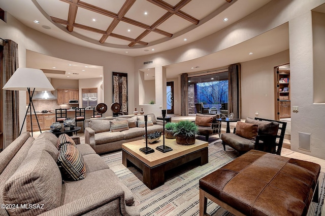 living room with beamed ceiling, a high ceiling, and coffered ceiling