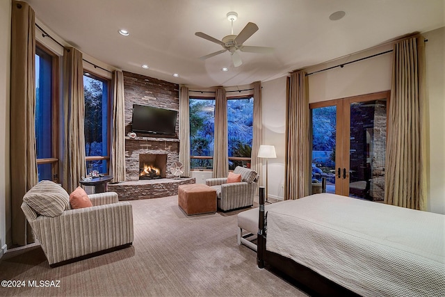 bedroom featuring access to exterior, ceiling fan, french doors, carpet floors, and a fireplace