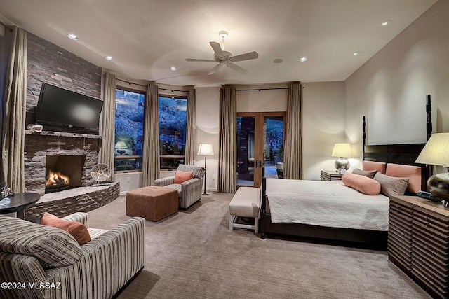 carpeted bedroom with a fireplace, french doors, access to outside, and ceiling fan