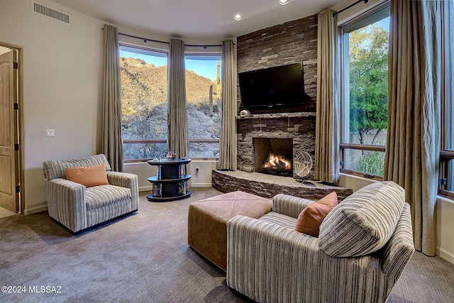 carpeted living room featuring a fireplace