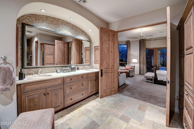 bathroom with vanity, ceiling fan, and lofted ceiling