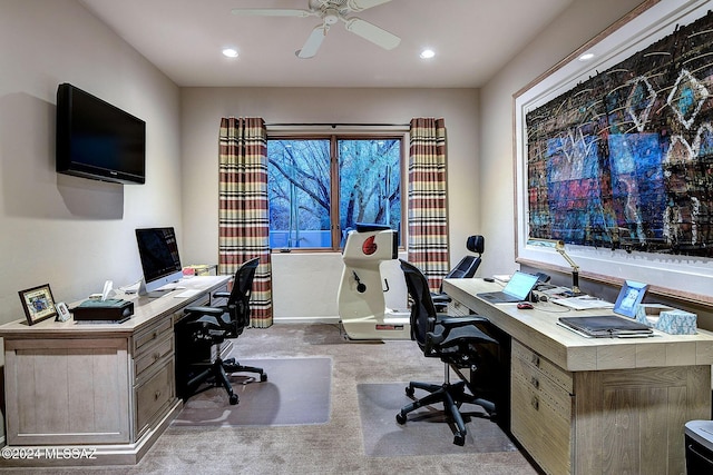 carpeted office space featuring ceiling fan