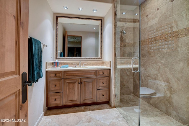 bathroom with tile patterned flooring, vanity, and walk in shower