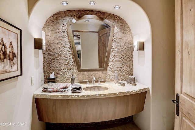 bathroom with decorative backsplash and vanity