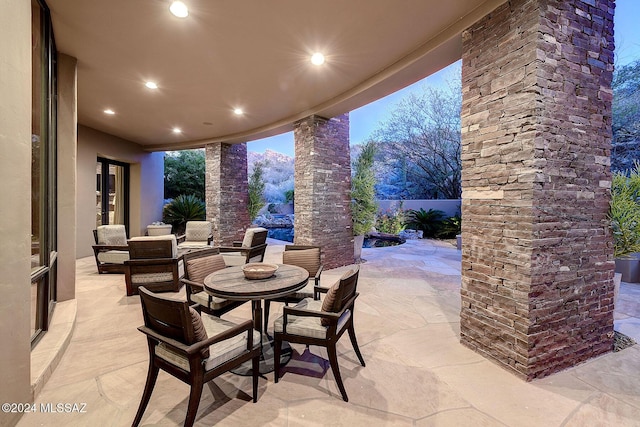 view of patio terrace at dusk