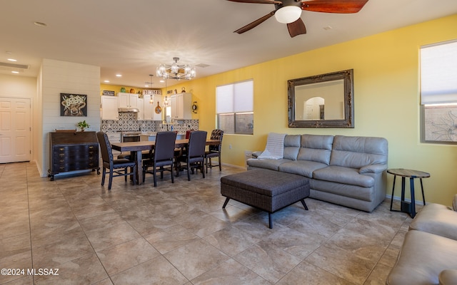 kitchen featuring a kitchen bar, stainless steel appliances, white cabinets, kitchen peninsula, and hanging light fixtures