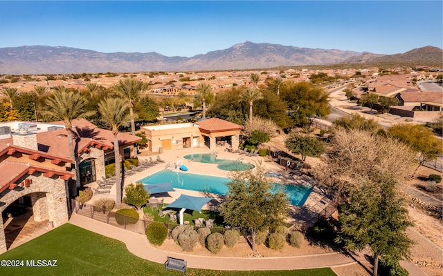 rear view of house with a mountain view, a yard, and a pergola