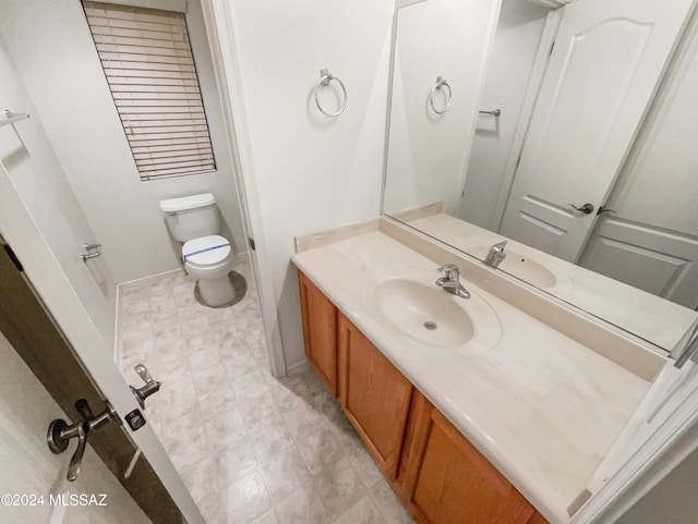 bathroom with toilet and vanity