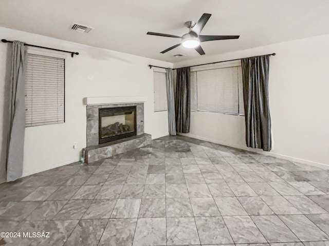 unfurnished living room featuring ceiling fan