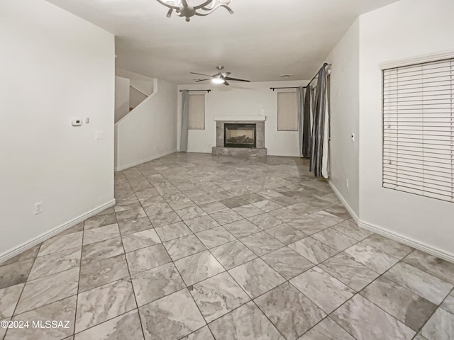 unfurnished living room featuring ceiling fan