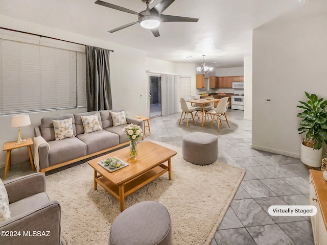 living room featuring ceiling fan with notable chandelier