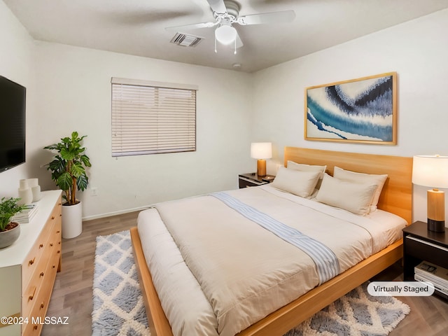 bedroom with light wood-type flooring and ceiling fan