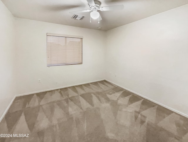 carpeted empty room featuring ceiling fan