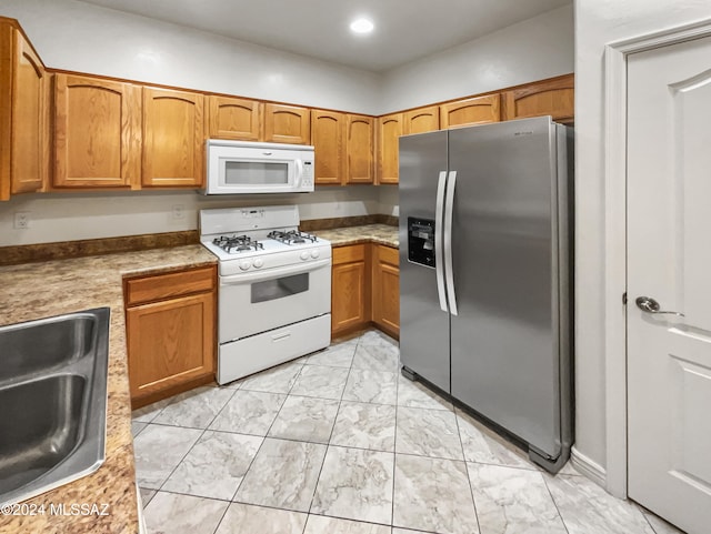 kitchen featuring white appliances and sink