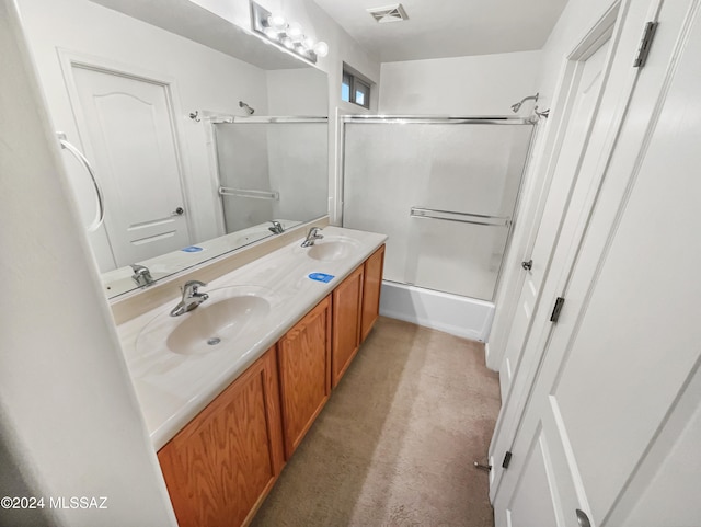 bathroom with vanity and bath / shower combo with glass door