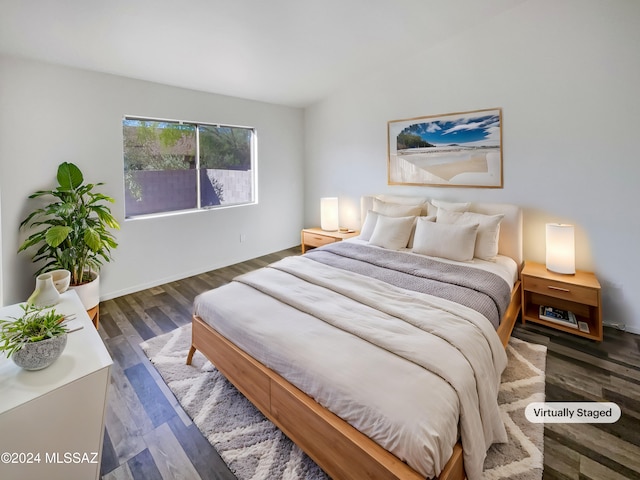 bedroom with dark hardwood / wood-style flooring