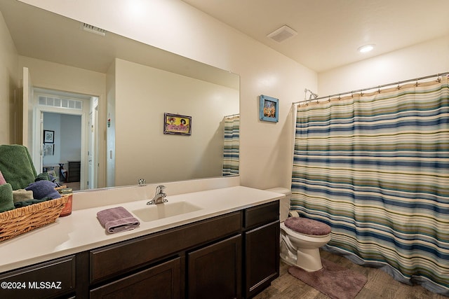 bathroom with vanity, toilet, and curtained shower