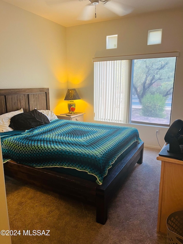 bedroom featuring ceiling fan and dark carpet