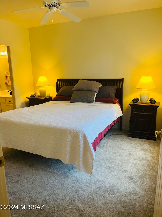 carpeted bedroom featuring ceiling fan and sink