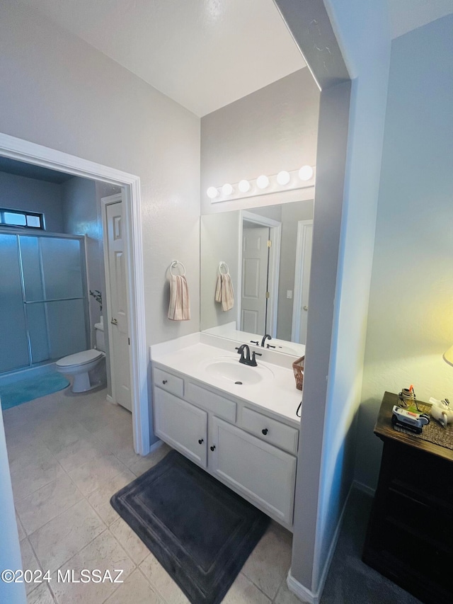 bathroom with vanity, tile patterned flooring, and toilet