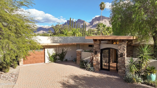 view of front facade with a mountain view and a garage