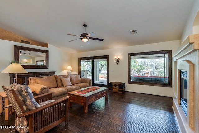 living room with a healthy amount of sunlight, lofted ceiling, dark hardwood / wood-style floors, and ceiling fan