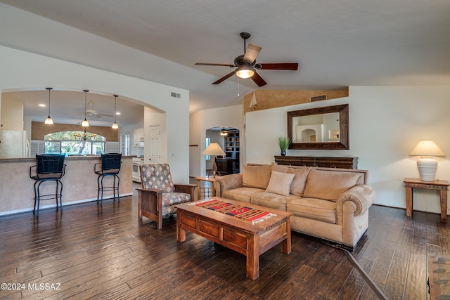 living room with ceiling fan, dark hardwood / wood-style floors, and vaulted ceiling