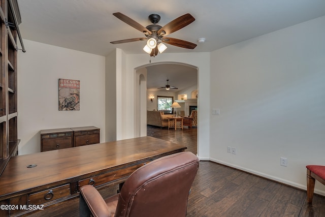 home office featuring dark wood-type flooring and ceiling fan