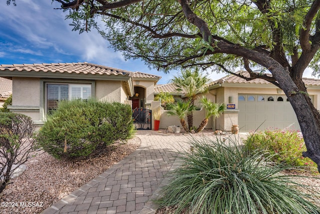 mediterranean / spanish-style home with a garage