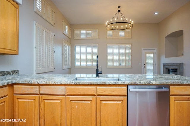 kitchen with dishwasher, a healthy amount of sunlight, kitchen peninsula, and sink