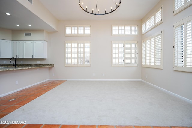 interior space featuring recessed lighting, visible vents, an inviting chandelier, light carpet, and baseboards